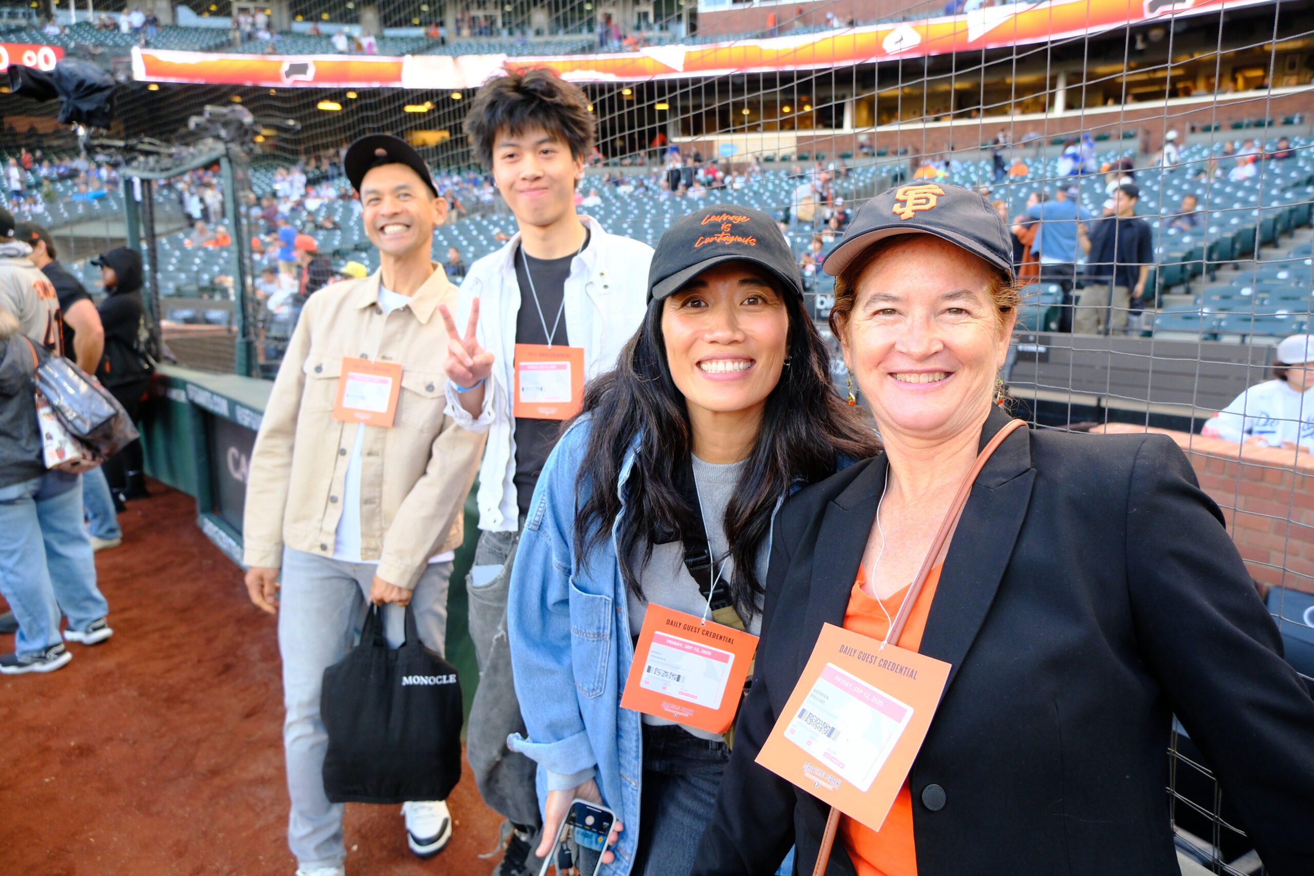 Attendees smiling on the field during the Courage Museum’s Strike Out Violence event with the San Francisco Giants.