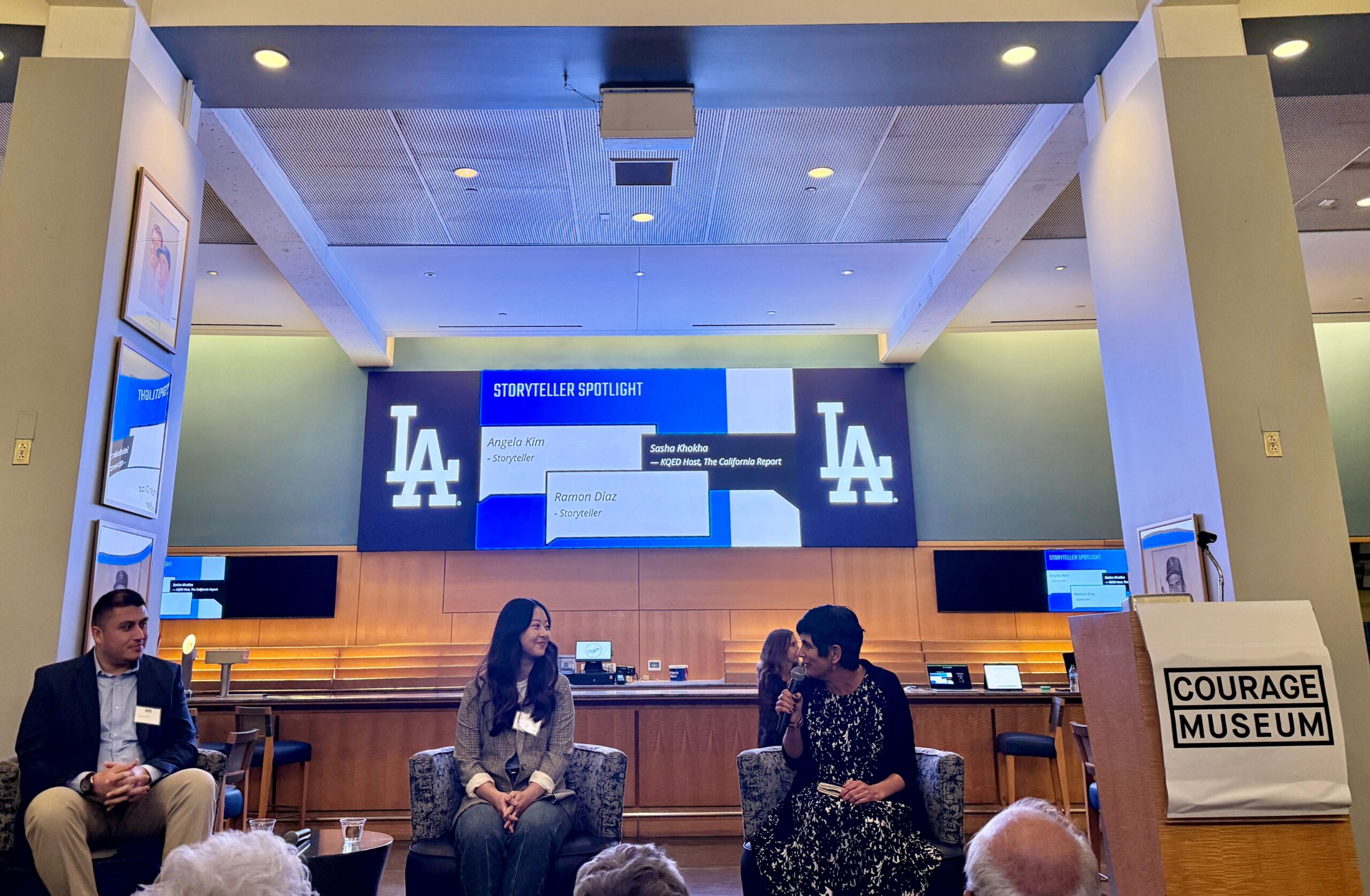 Panel discussion at Dodger Stadium featuring Courage Museum storyteller speakers seated on stage during a special event with museum supporters.